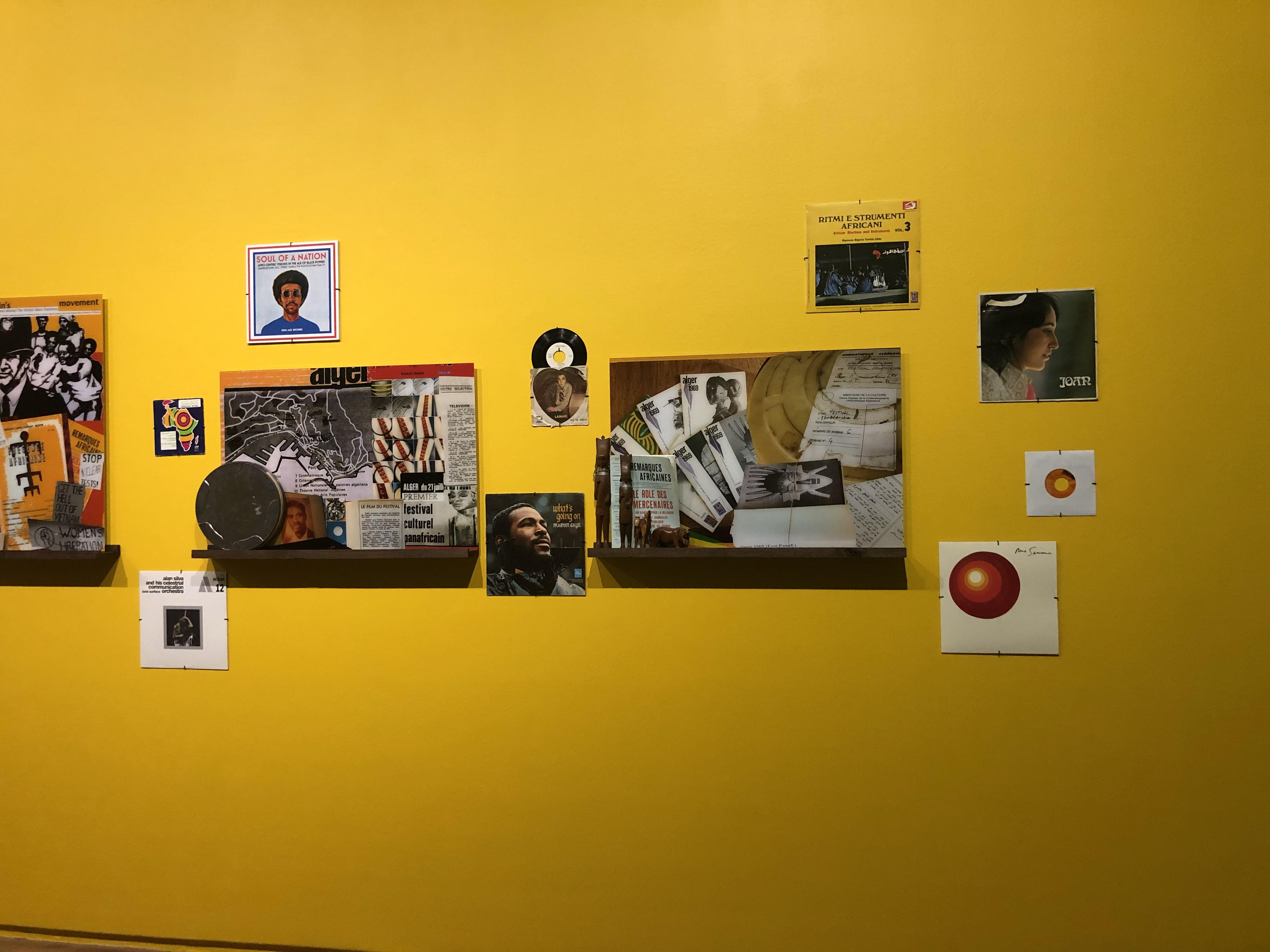 Closeup of two wall mounted display boards - surrounded by vinyl music records including Marvin Gaye, Joan Baez, Soul of a Nation