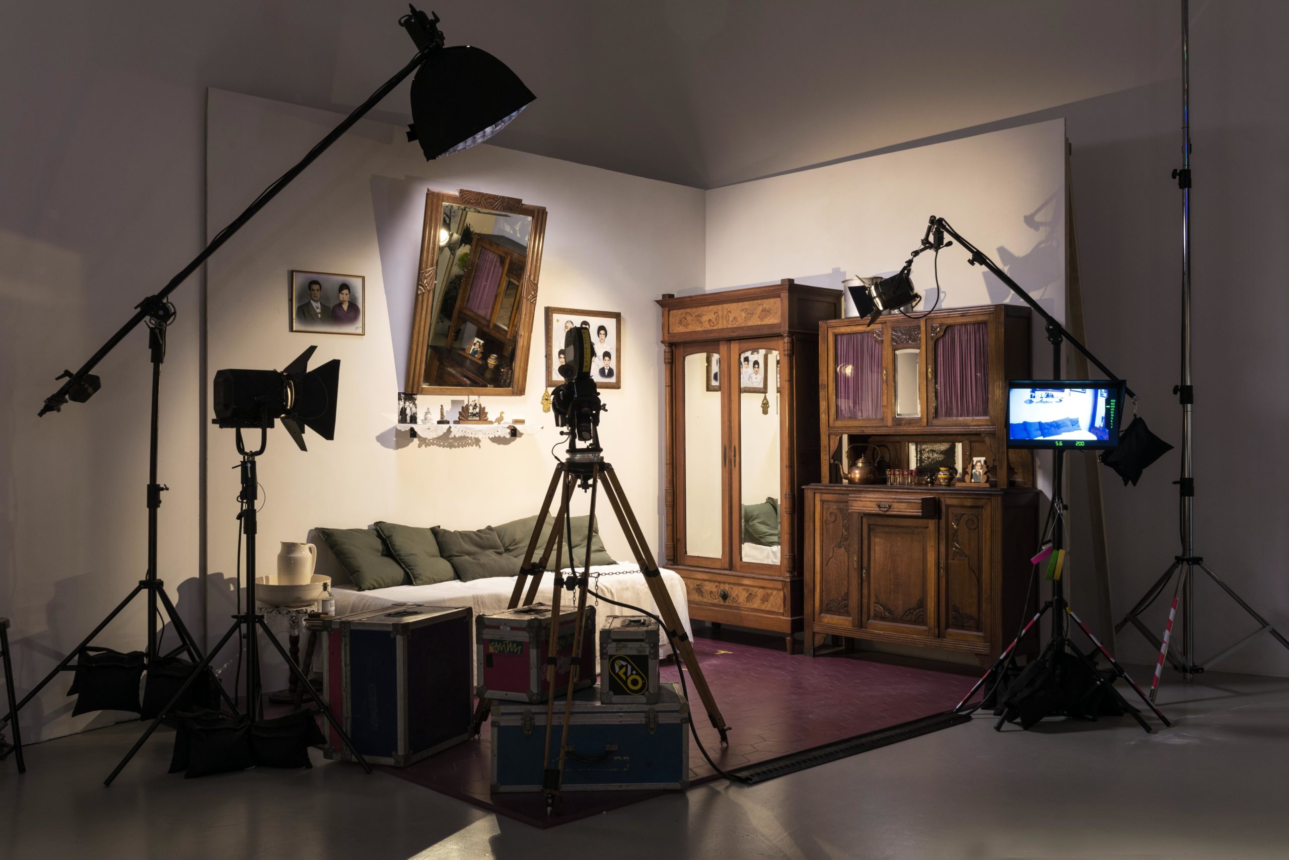 Film set with lights around bed, wardrobe and sideboard